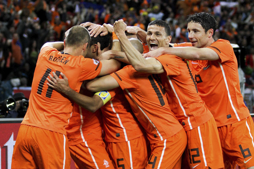 The Netherlands celebrate Giovanni van Bronckhorst's stunning opening goal against Uruguay in the World Cup semi-final.